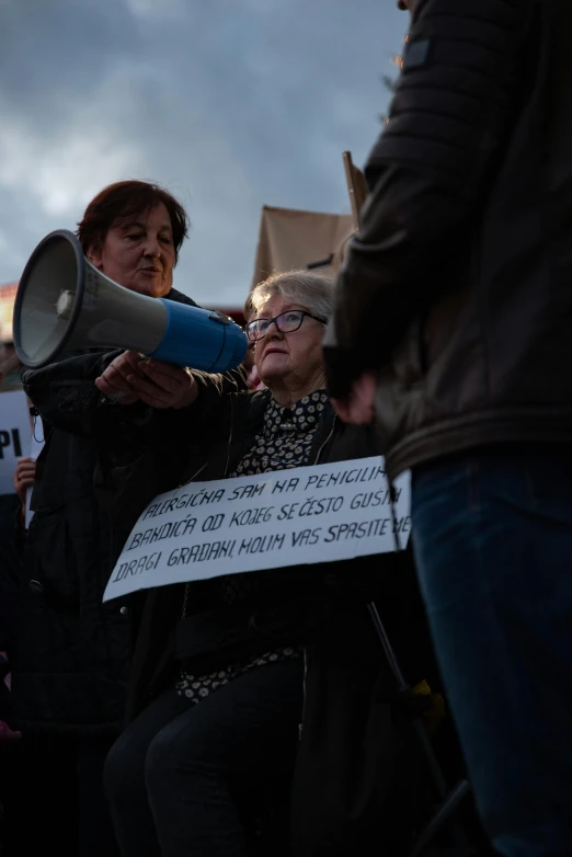 an older woman shouting into a megaphone