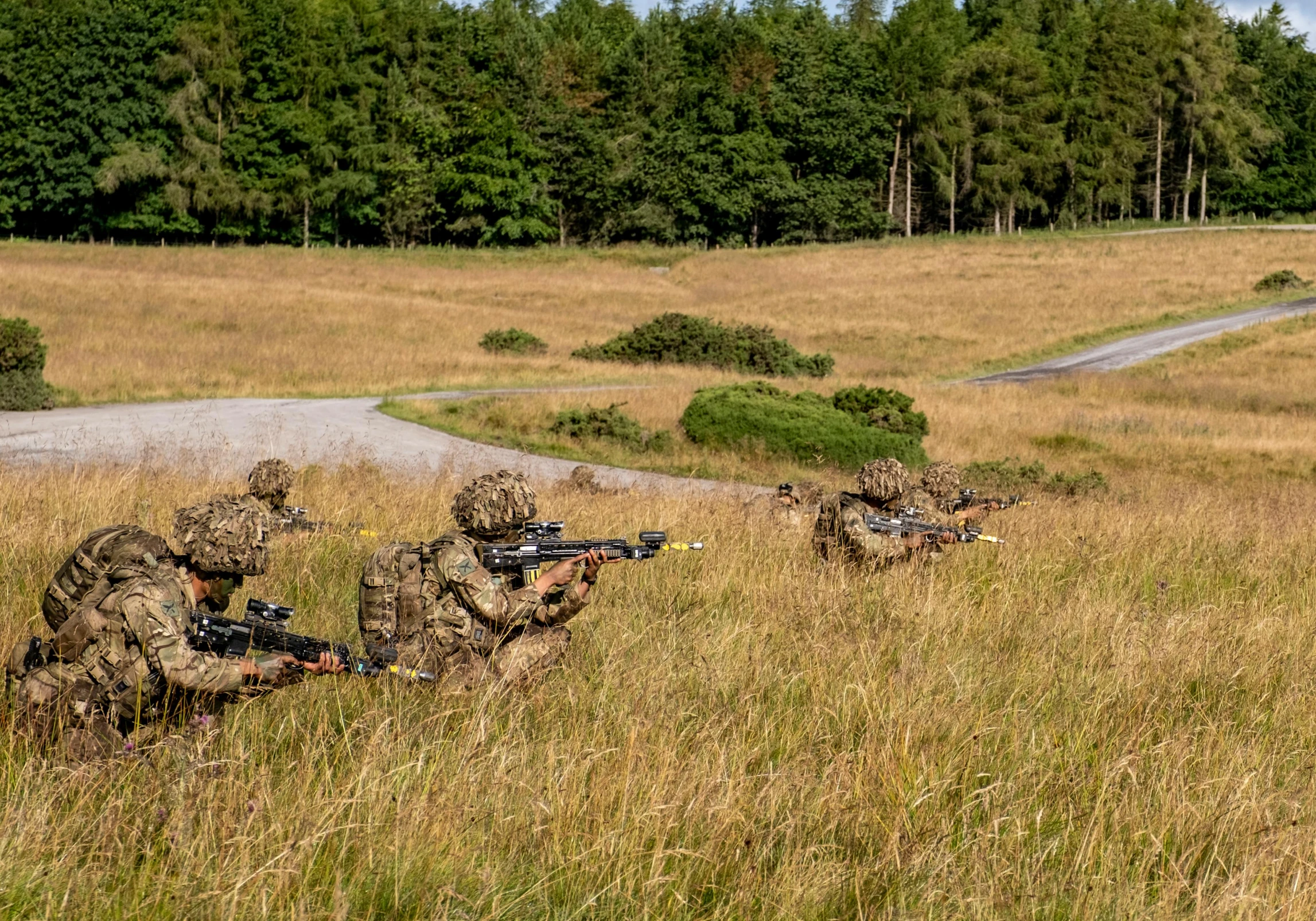 four soldiers are hunting in the field