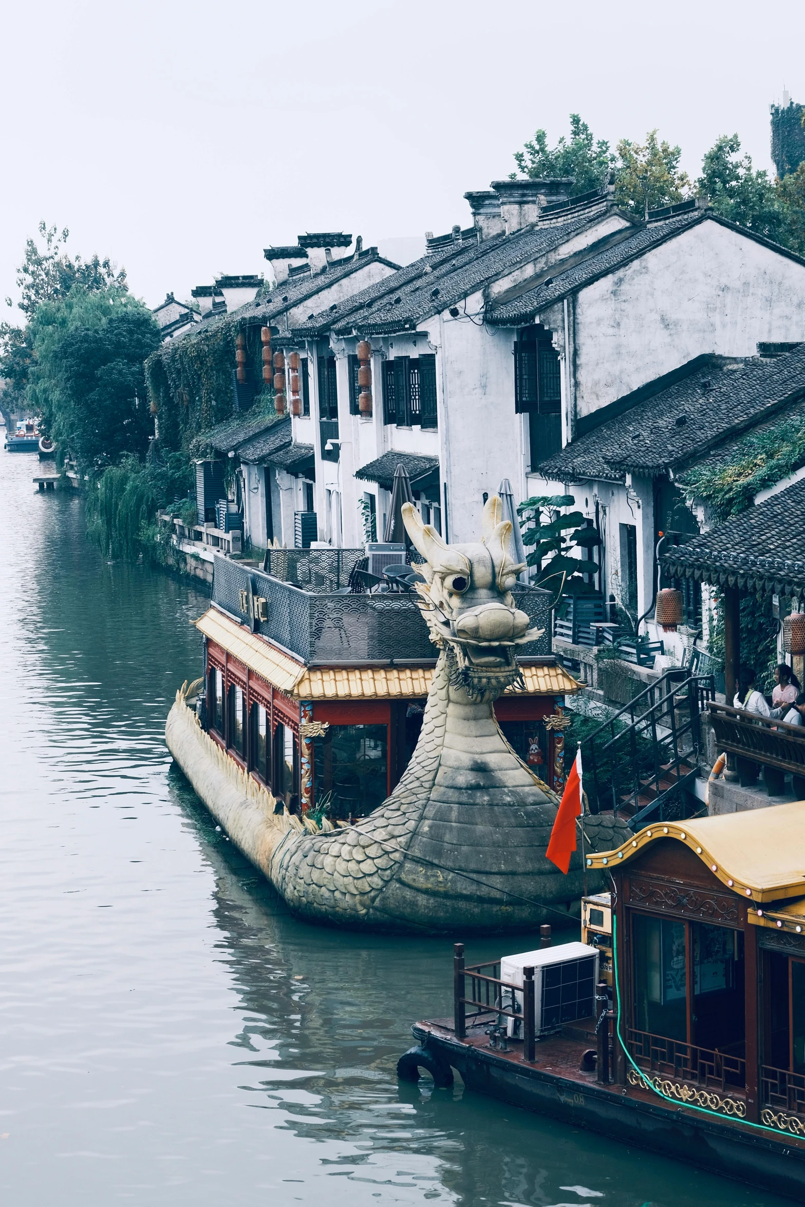 two boats on the water with houses next to them