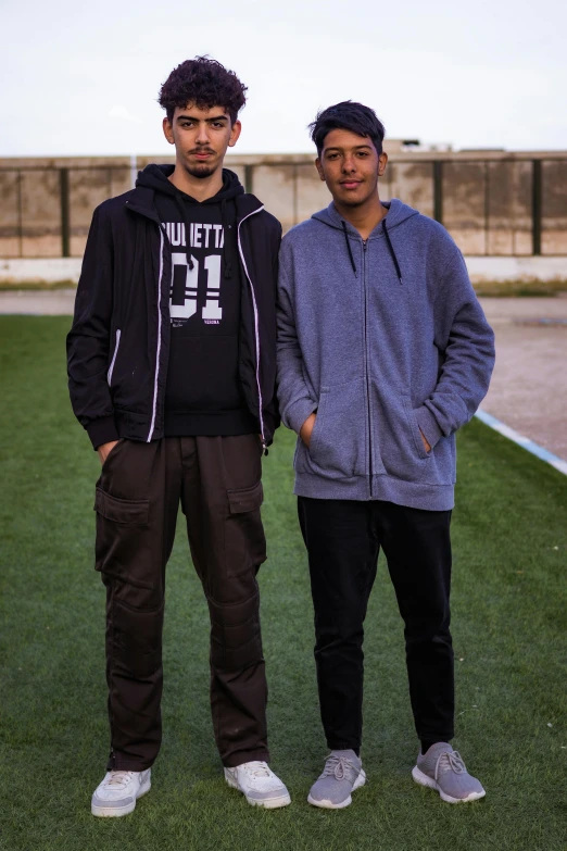 two men in hoods stand next to each other