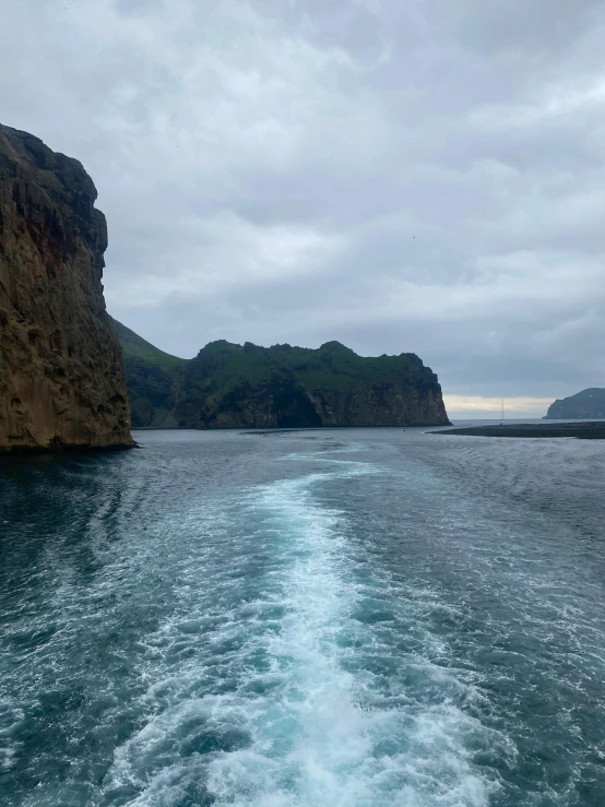 a boat with a body of water near some mountain