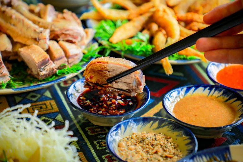 the table contains many asian dishes on it