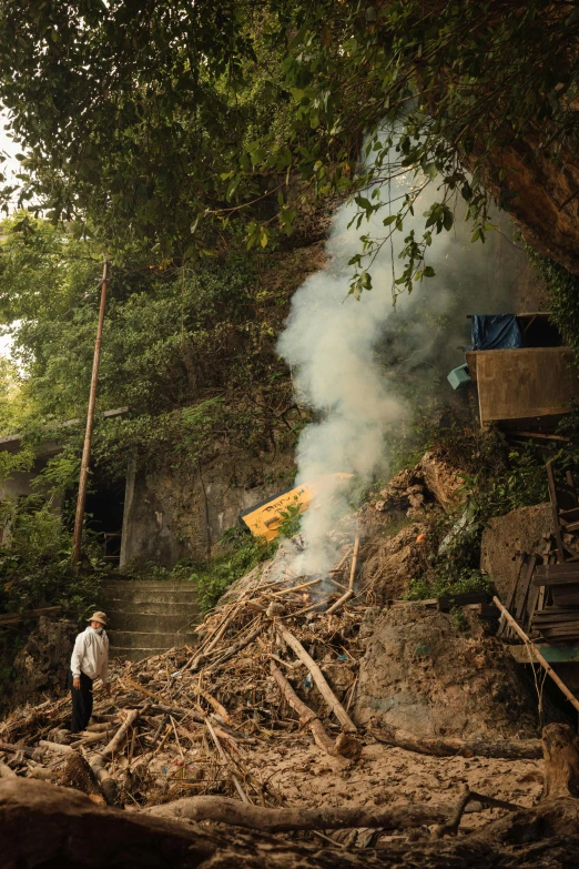 a man is standing at the bottom of stairs near a smoke stack