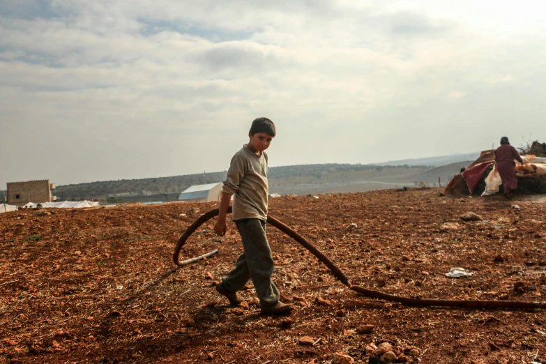 a person standing on top of a brown dirt field