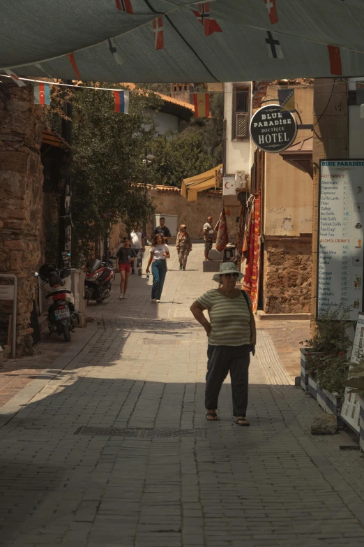 an older man walking down a stone pathway