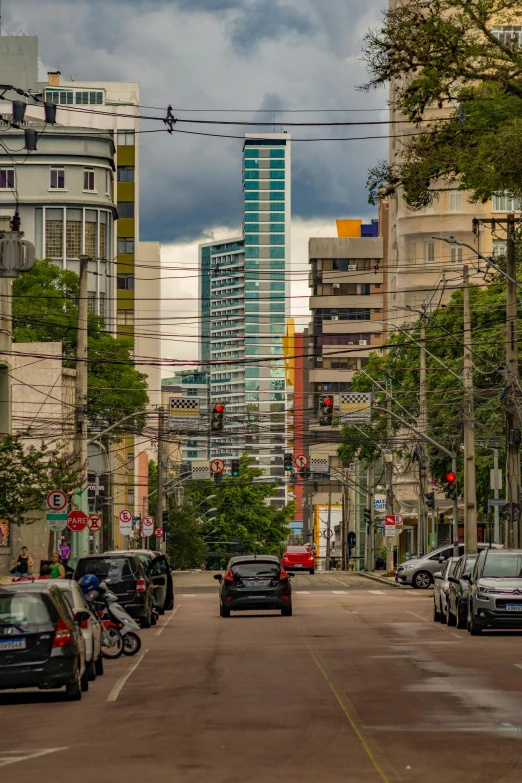 cars parked on a city street near tall buildings