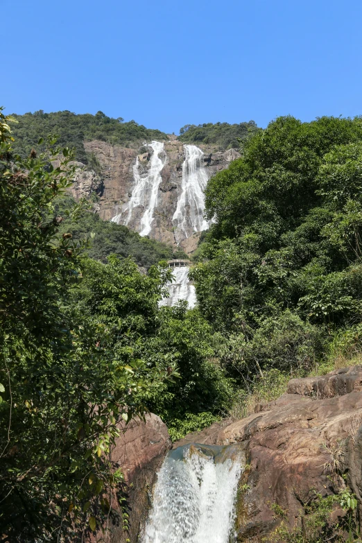 there is a very tall waterfall going over the water