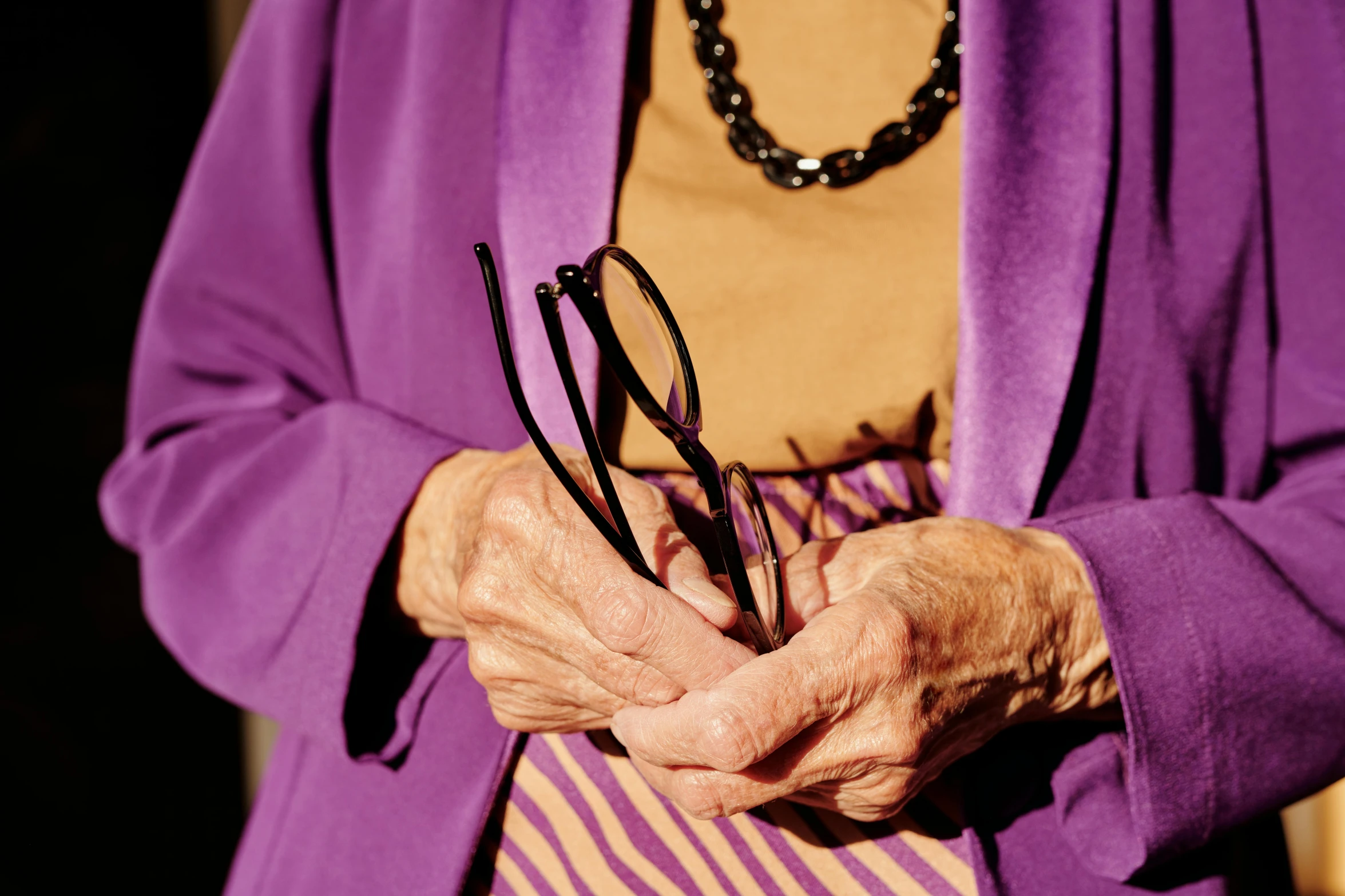 a woman in a purple robe holding some glasses