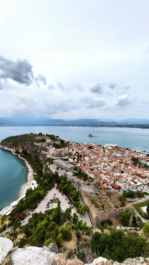 an aerial view of a very small town by a large body of water