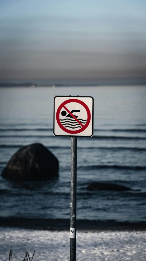 a sign that is sitting in the sand