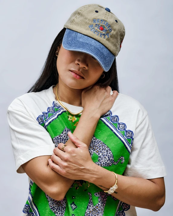 a beautiful woman in a hat with her arms folded