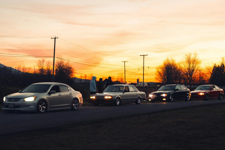 group of cars parked next to each other on side of street