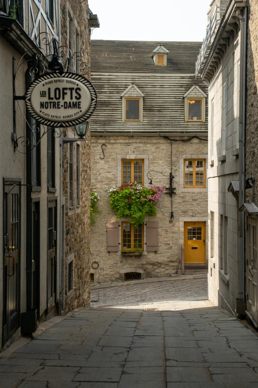 an alleyway in a historic village with a building and yellow doors