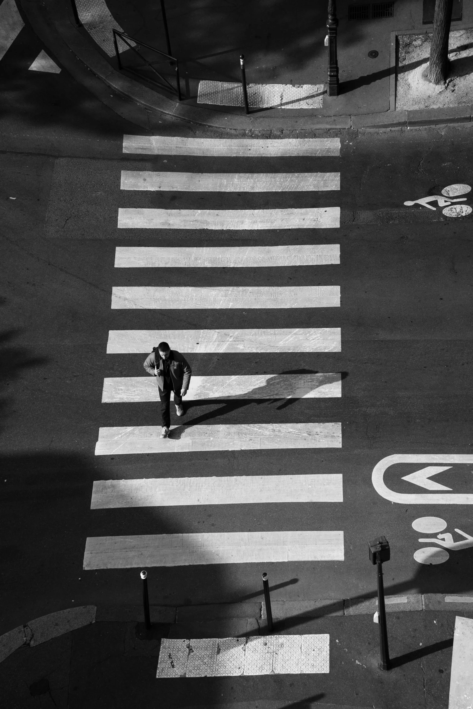 a man crossing a street in a crosswalk