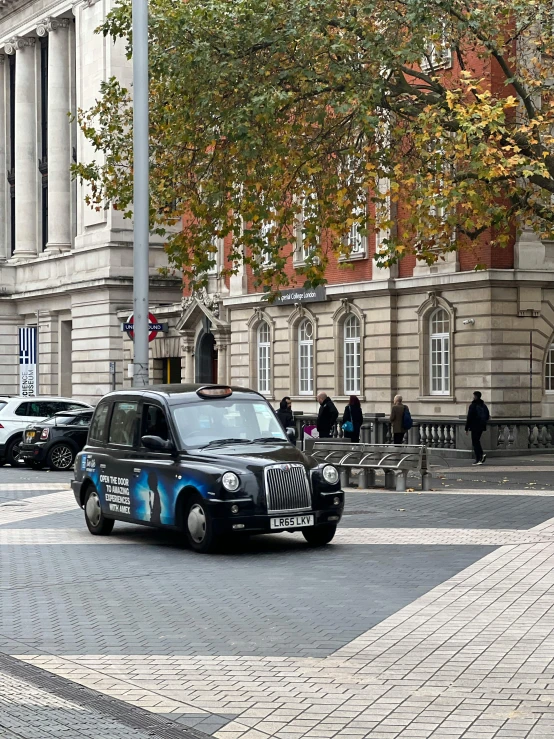 a car parked outside of a building with people