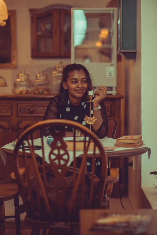 a woman sitting at a table with food in her hand