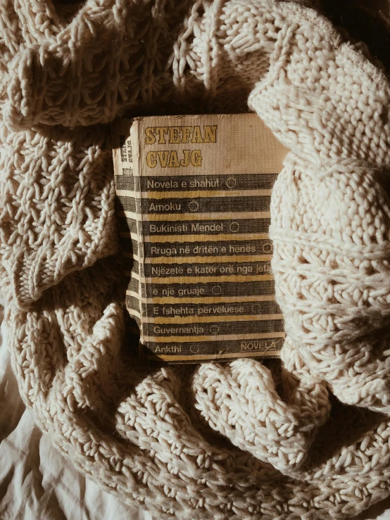 a book covered with a white knit