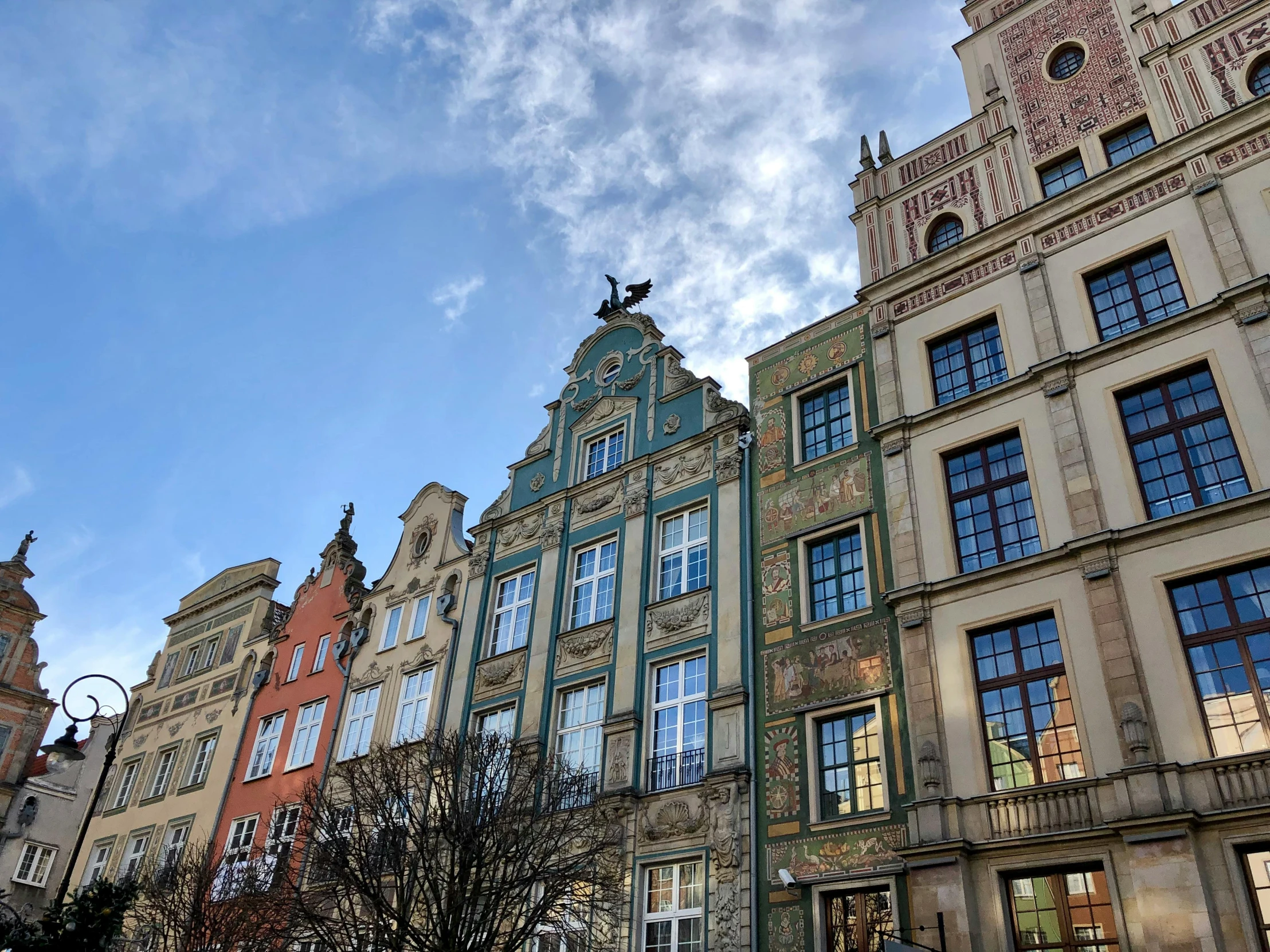 a tall building with many windows and a street sign in front of it