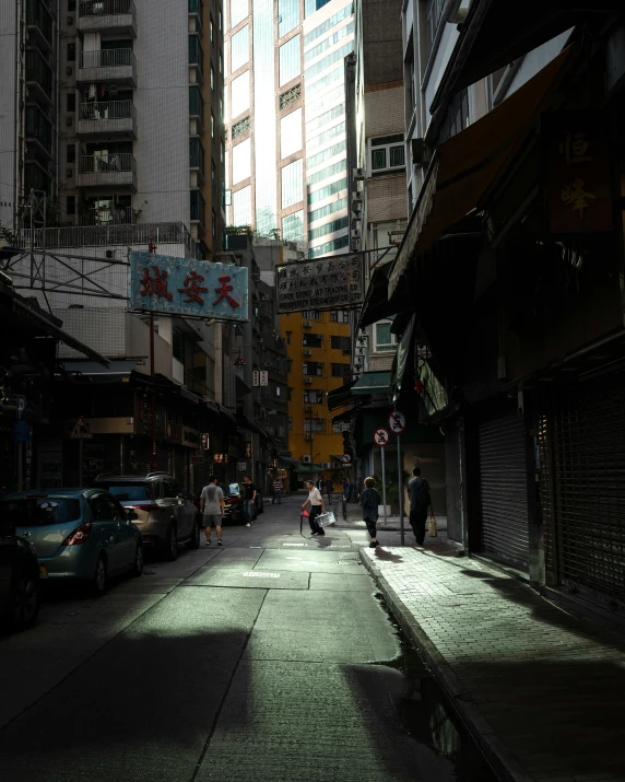 a couple of people walk down a city street