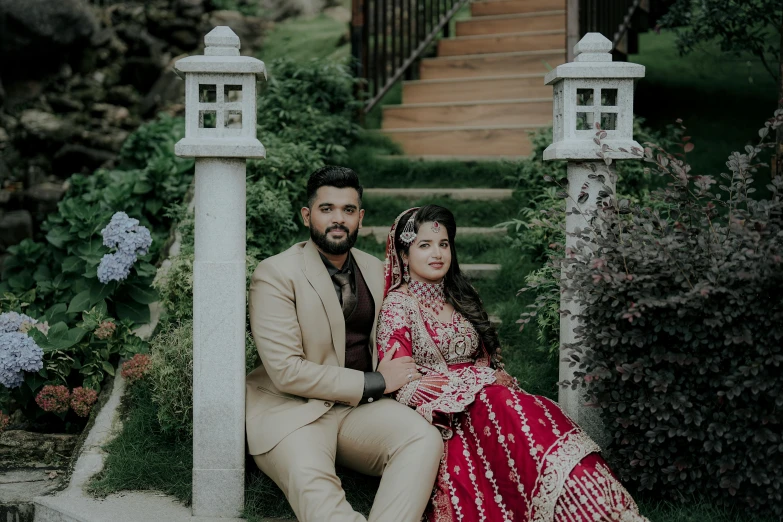 the couple is sitting on a post by the stairs