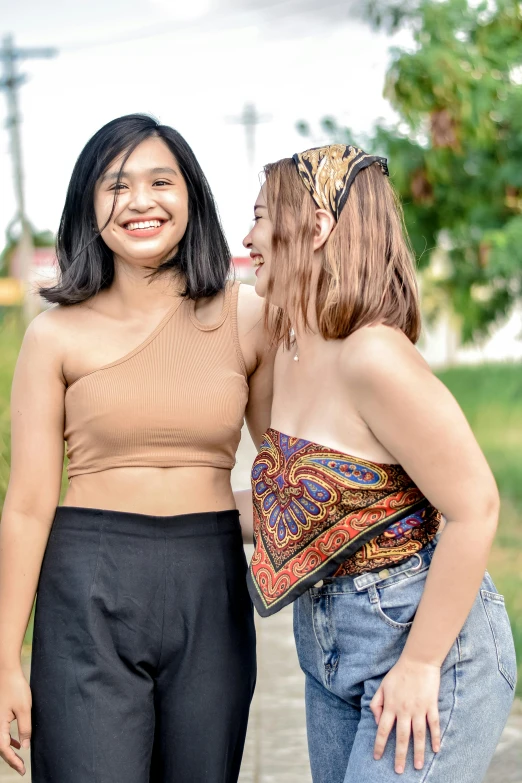 two women are standing outside near each other