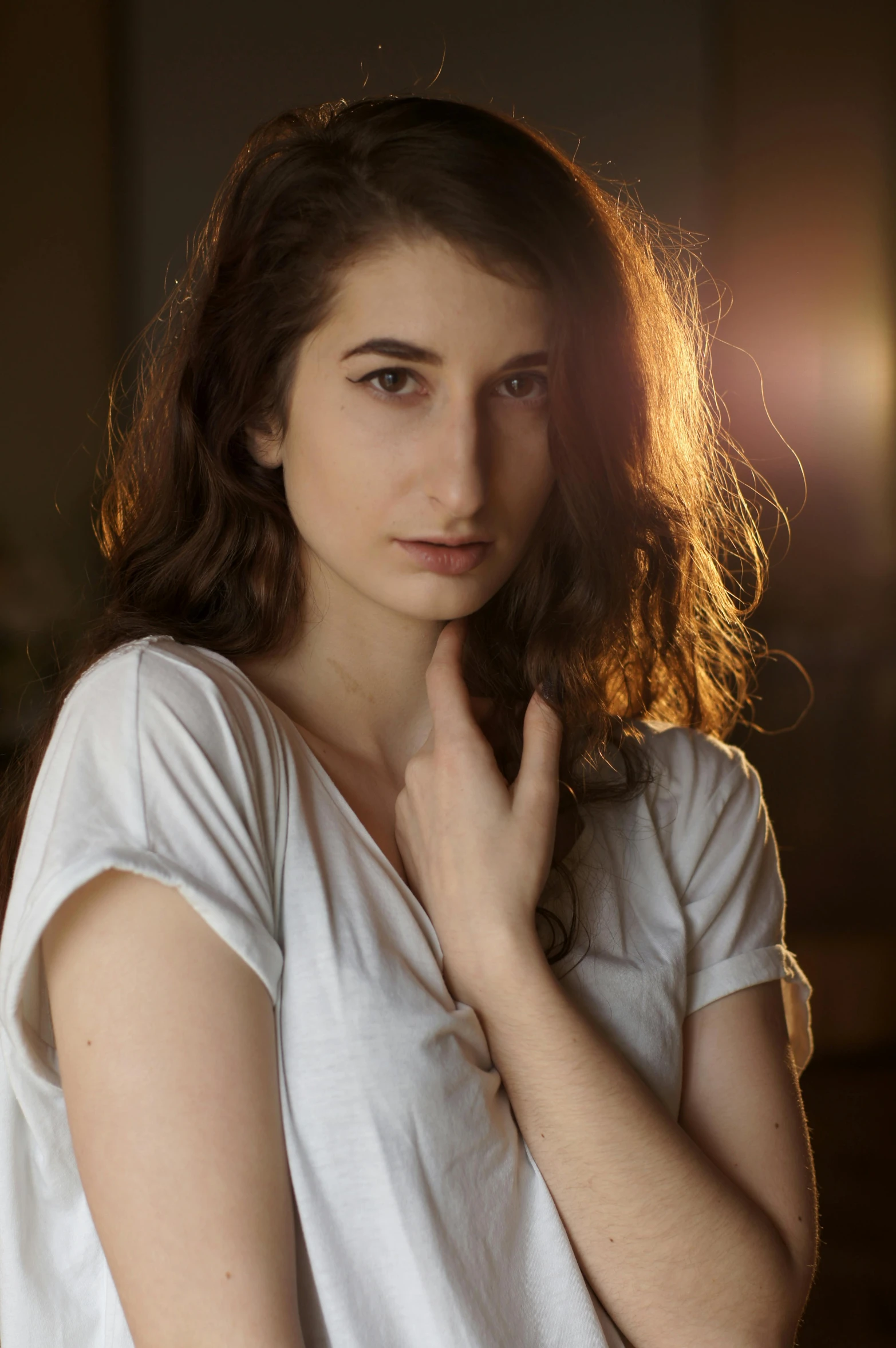 a girl in a white shirt poses with her hands together