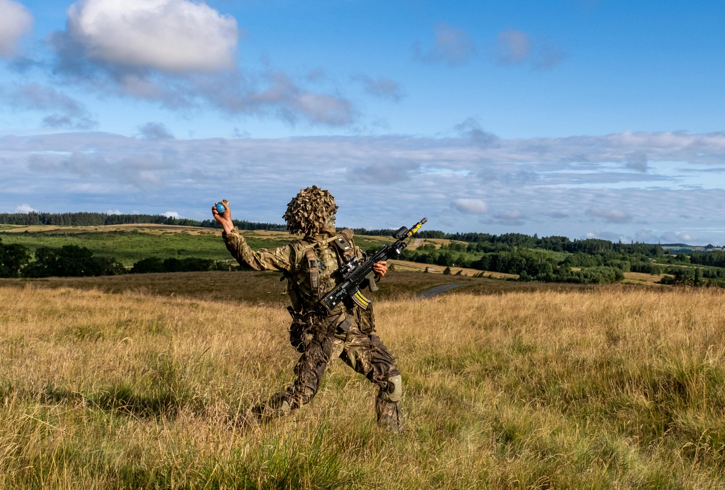 a person is in a field with no boots and one hand out