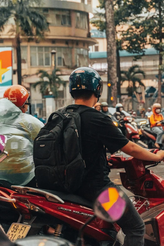 several people are sitting on scooters in a row