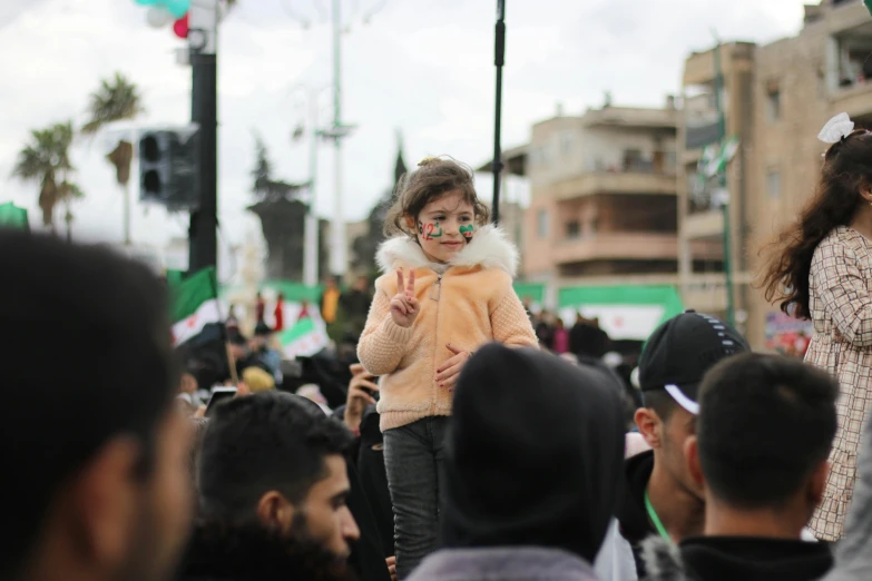 a woman with face paint walking through a crowd of people