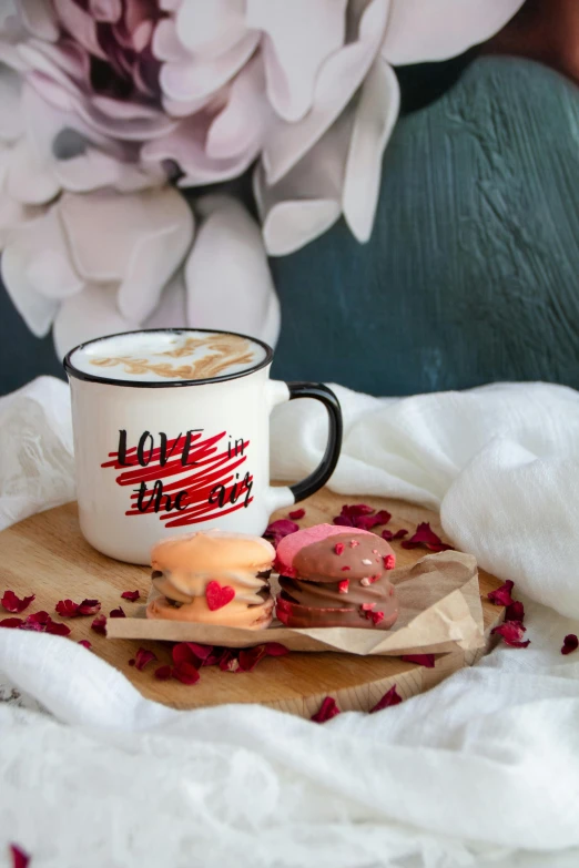 a cup and spoon sitting on a piece of wood