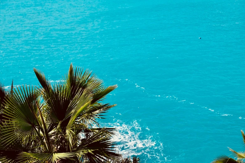 two boats floating close to each other on the ocean