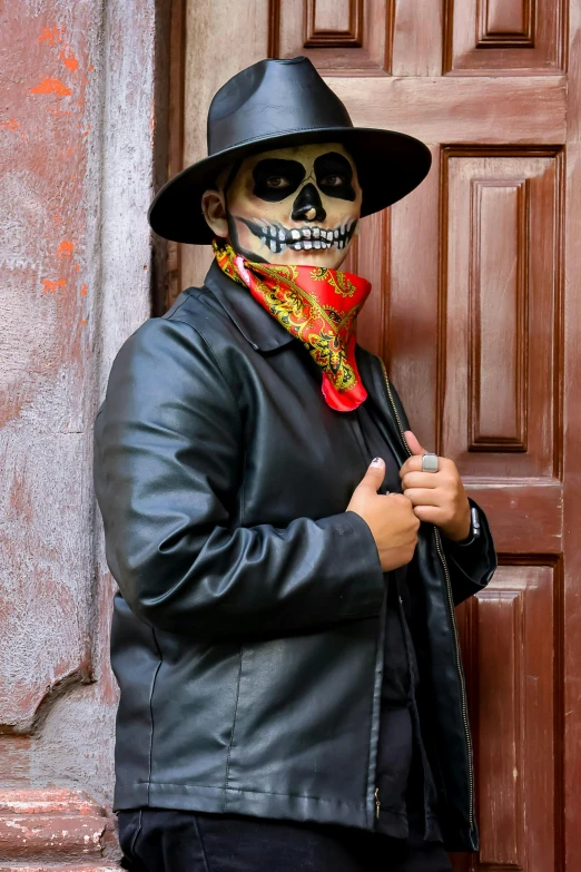 a man with a skeleton face paint on his face and coat