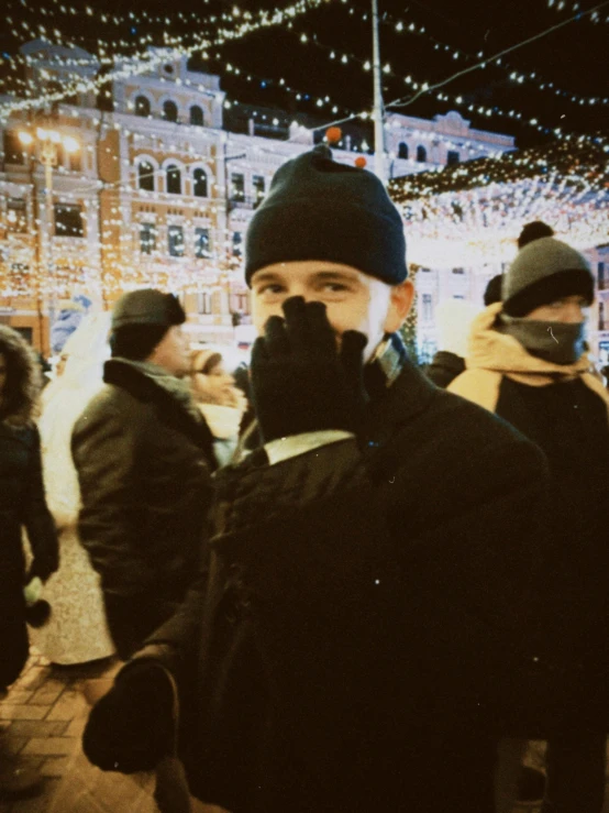 a man wearing ski gloves, a beanie and a jacket and scarf