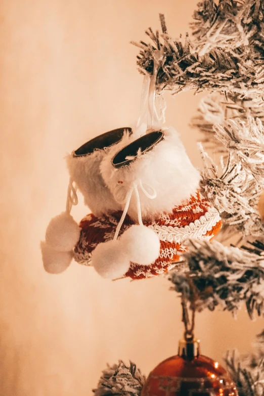 a small christmas ornament with two mittens on it