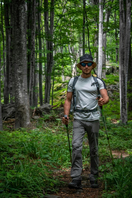a man hiking through the forest in the wilderness