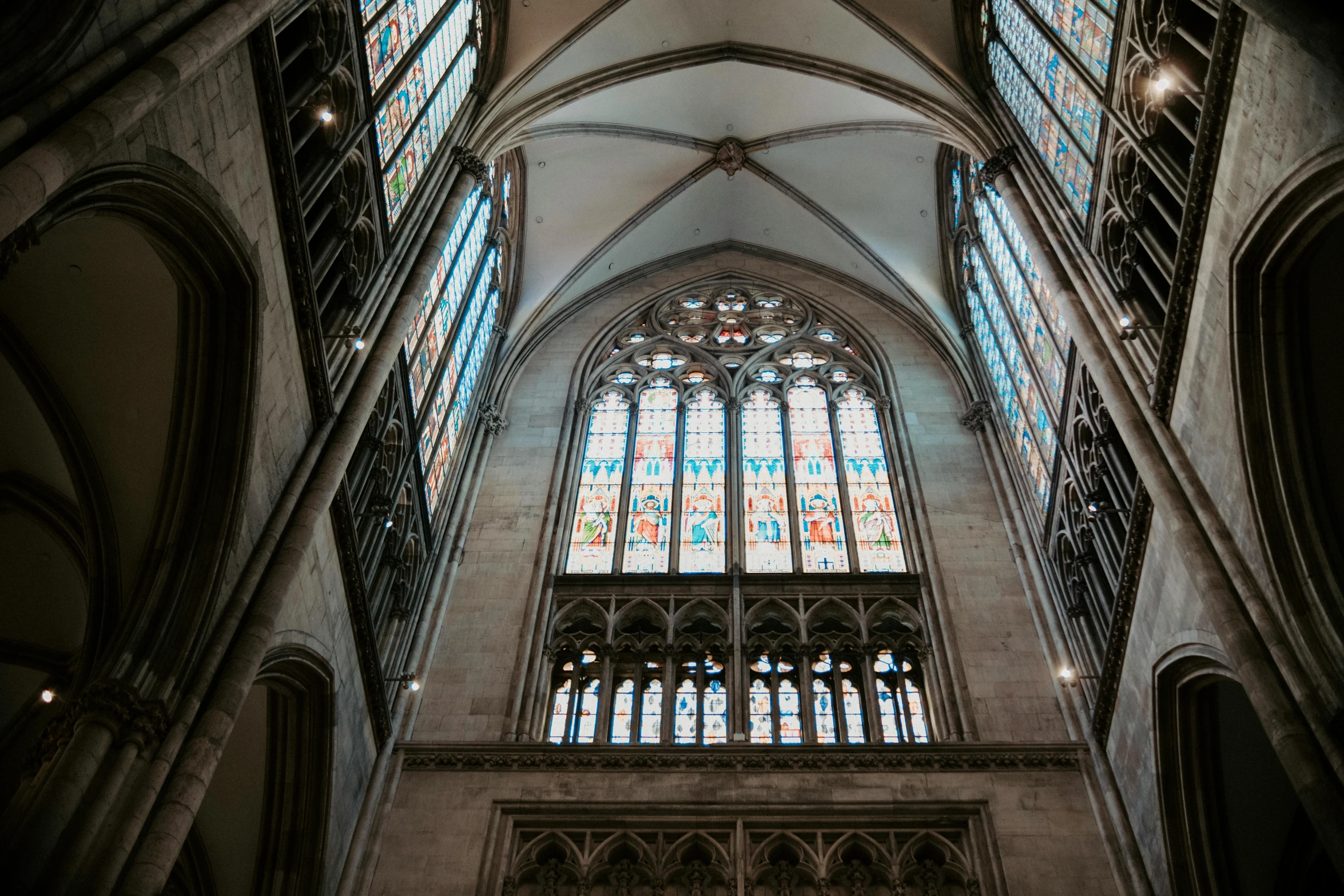 large stained glass windows at a high ceiling cathedral
