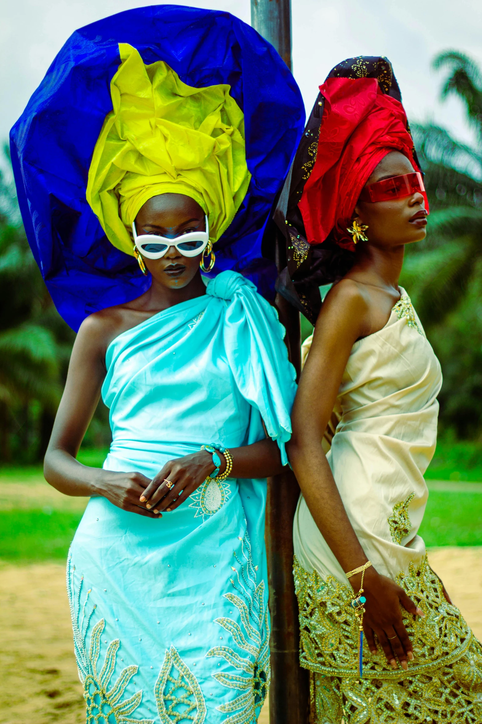 two women wearing colorful headgear and masks