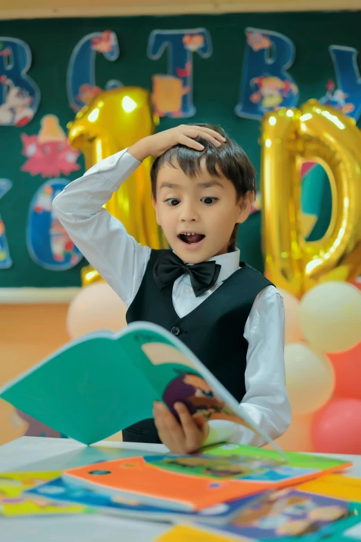 a young child wearing a bow tie reading a book