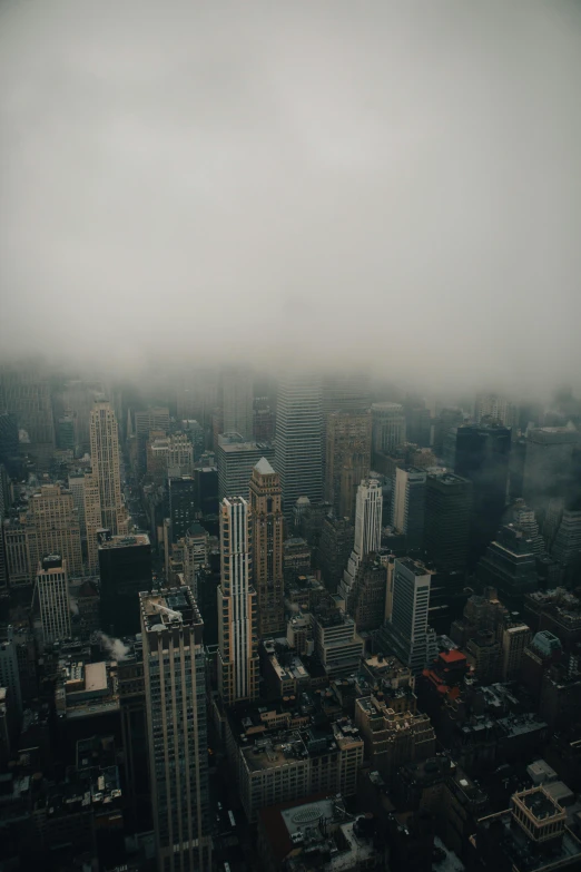 a view of a city skyline with tall buildings and fog