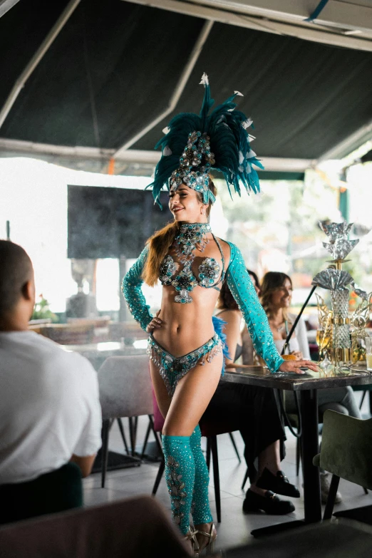 a dancer in turquoise at an outdoor eatery