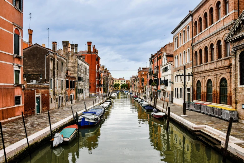 a canal in front of some buildings next to each other