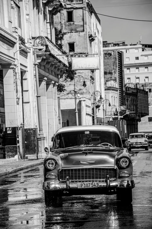 a classic car in front of some buildings