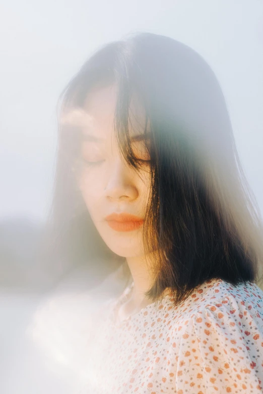 a woman with long hair is staring away