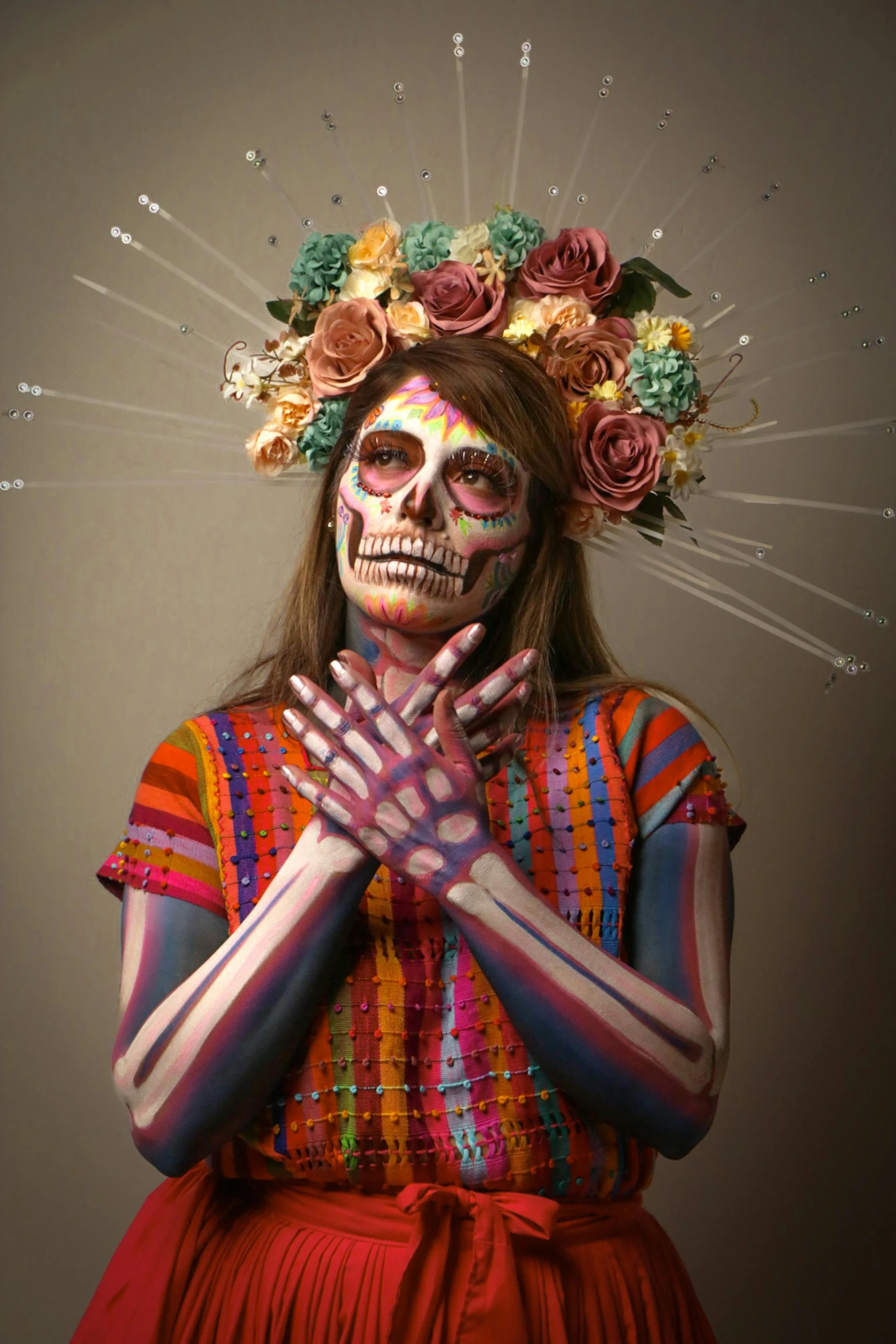 a woman with colorful makeup on and her hands folded up