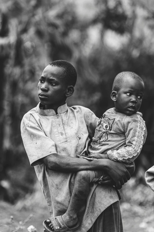 two men carrying a child on their shoulders