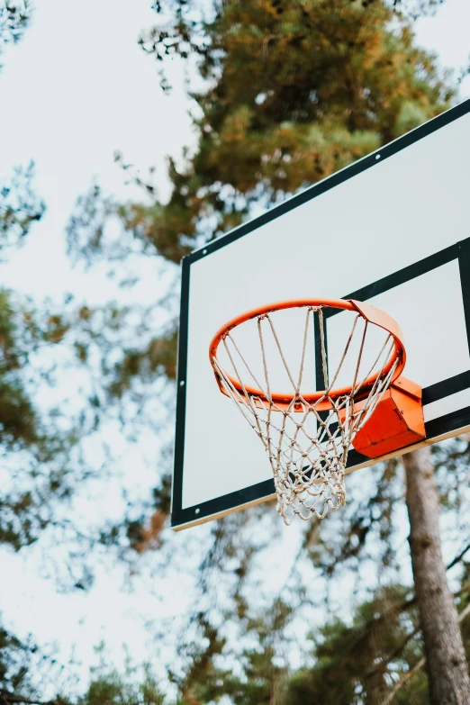 an orange basketball flies through the basket