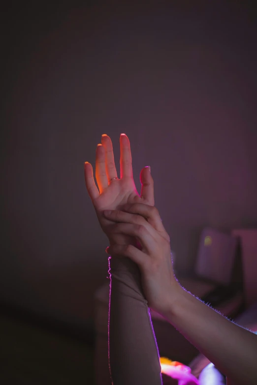 two hands with lights in the background