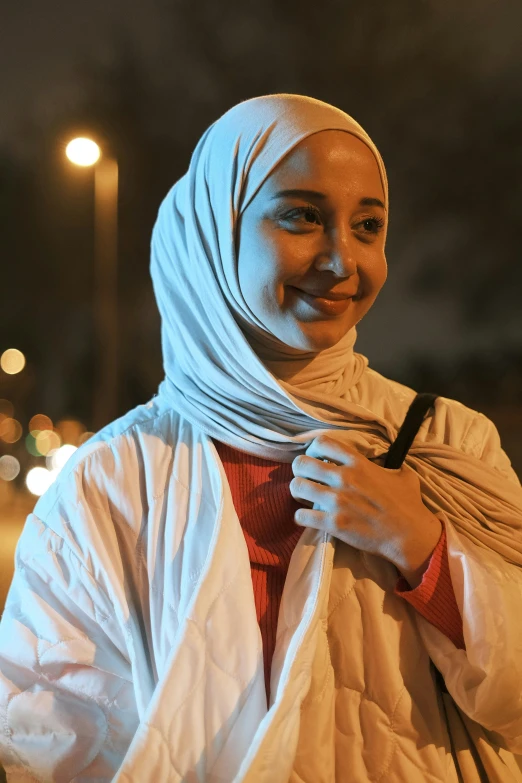 an indian woman standing in front of a light