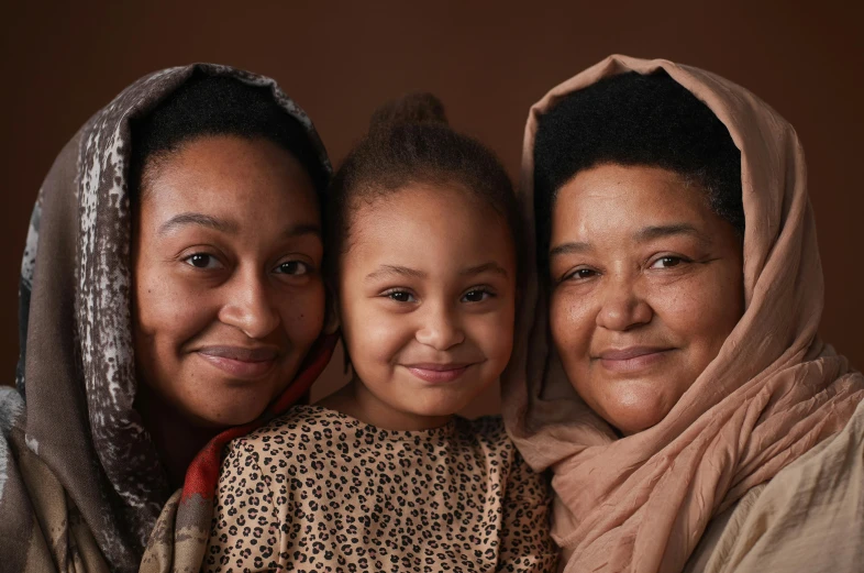 a  smiling next to her mother and older sister