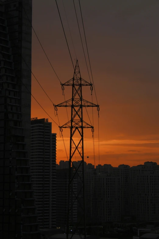 a very tall tower with some power lines above it